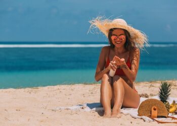 Chica poniéndose protector solar